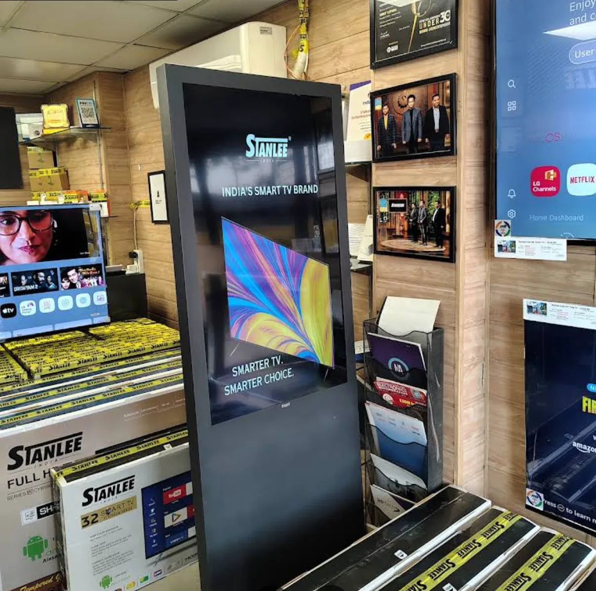 Inside the Ghaziabad store — boxed Stanlee televisions, the wall displays and the branded kiosk, photographed by the reviewer